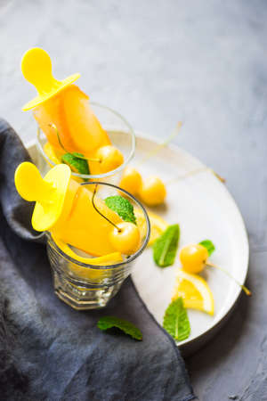 Summer dessert with lemon and mint on rustic wooden background with copyspace