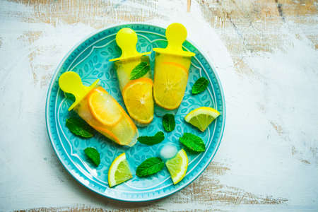 Summer dessert with lemon and mint on rustic wooden background with copyspaceの写真素材