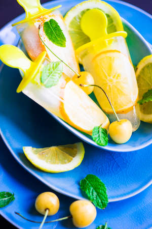 Summer dessert with lemon and mint on rustic wooden background with copyspaceの写真素材