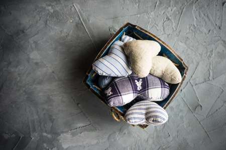 busket full of hearts on rustic concrete background with copyspace