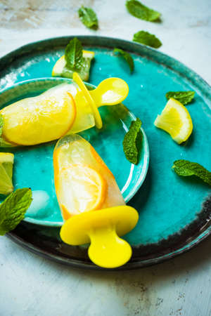 Summer dessert with lemon and mint on rustic wooden background with copyspaceの写真素材