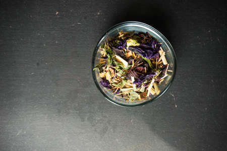 Different types of tea, green tea, peony and ginger tea, rose bud and wild flowers tea on dark wooden background with copyspaceの写真素材