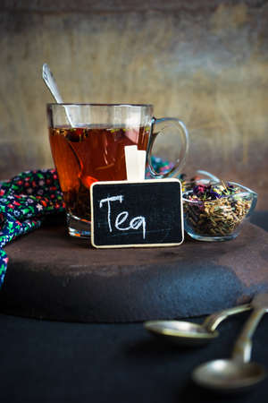 Different types of tea, green tea, peony and ginger tea, rose bud and wild flowers tea on dark wooden background with copyspaceの写真素材