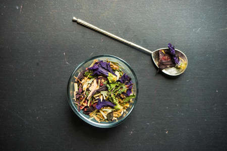 Different types of tea, green tea, peony and ginger tea, rose bud and wild flowers tea on dark wooden background with copyspaceの写真素材