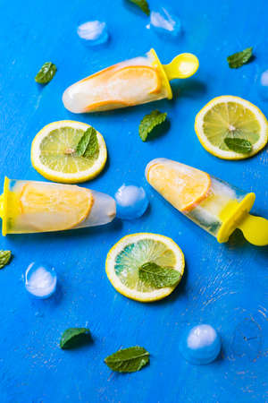 Summer dessert with lemon and mint on rustic wooden background with copyspaceの写真素材