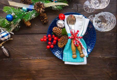 Festive table setting for Christmas holiday dinner with vintage flatware and decoration