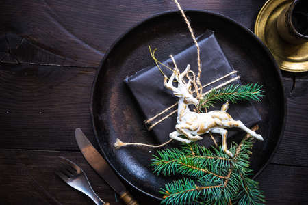 Festive table setting for Christmas holiday dinner with vintage flatware and decorationの写真素材