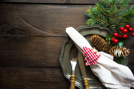 Festive table setting for Christmas holiday dinner with vintage flatware and decorationの写真素材