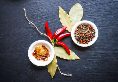 Spices withdifferent types of pepper on dark background with copyspaceの写真素材