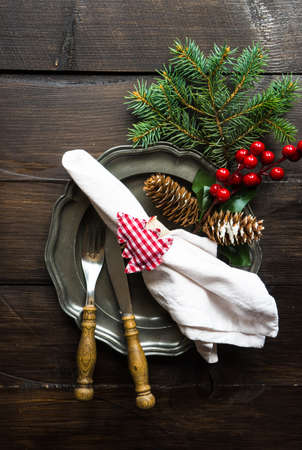Festive table setting for Christmas holiday dinner with vintage flatware and decorationの写真素材