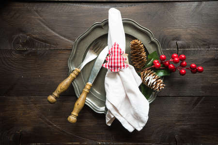 Festive table setting for Christmas holiday dinner with vintage flatware and decorationの写真素材