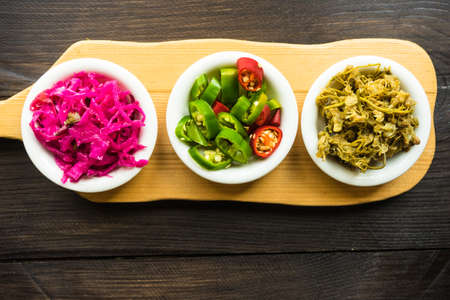 Traditional georgian salads and ingredients as a hot chili pepper, sour red cabbage and jonjoli or caucasian capersの写真素材