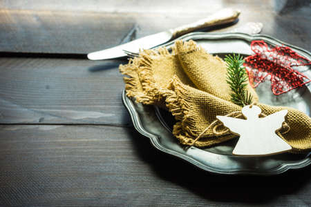 Festive table setting for Christmas holiday dinner with vintage flatware and decorationの写真素材