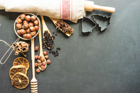 Christmas time cooking concept with flour and cookies forms on dark wooden table