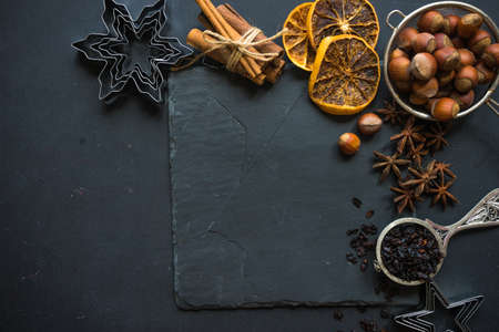 Christmas time cooking concept with flour and cookies forms on dark wooden tableの写真素材