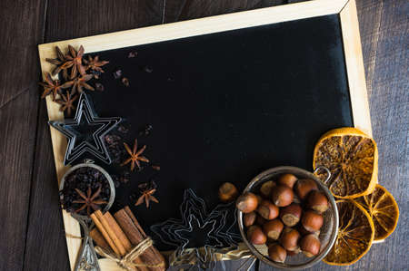 Christmas time cooking concept with flour and cookies forms on dark wooden tableの写真素材