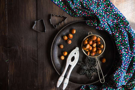 Christmas time cooking concept with flour and cookies forms on dark wooden tableの写真素材
