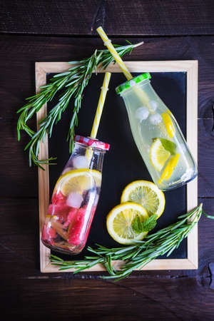 Detox drinks with mint, lemon, watermelon and rosemary in a vintage bottlesの写真素材