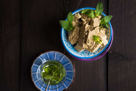 Traditional turkish sweets - pahlava with fresh mint leaves and mint teaの写真素材
