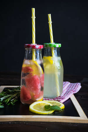 Detox drinks with mint, lemon, watermelon and rosemary in a vintage bottlesの写真素材