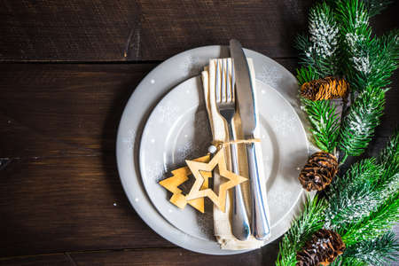 Festive table setting for Christmas holiday dinner with vintage flatware and decorationの写真素材