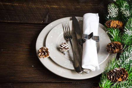 Festive table setting for Christmas holiday dinner with vintage flatware and decoration