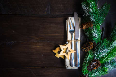 Festive table setting for Christmas holiday dinner with vintage flatware and decorationの写真素材