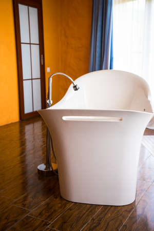Interior of big bathroom with centre located bathの写真素材