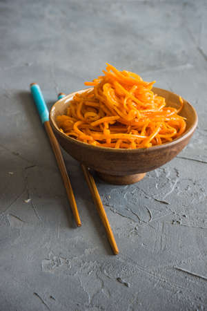 Organic spicy carrot salad on rustic table with copyspace as an organic food conceptの写真素材