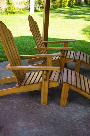 Old styled wooden park bench in a city parkの写真素材