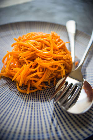 Organic spicy carrot salad on rustic table with copyspace as an organic food conceptの写真素材