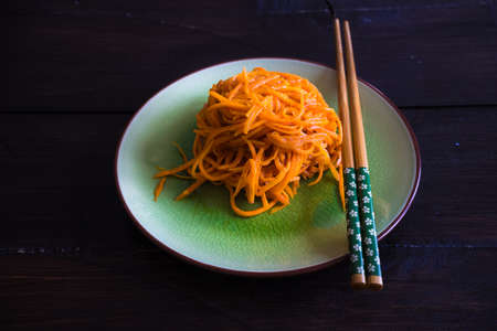 Organic spicy carrot salad on rustic table with copyspace as an organic food conceptの写真素材