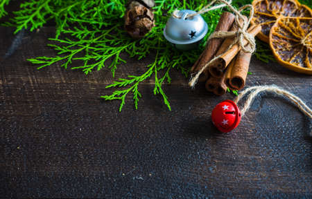 Christmas spices lika an anise star, cinnamon sticks and nuts on dark wooden tableの写真素材