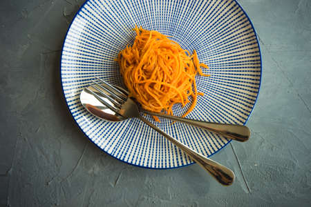 Organic spicy carrot salad on rustic table with copyspace as an organic food conceptの写真素材