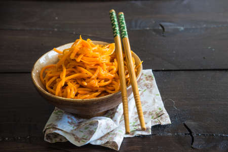 Organic spicy carrot salad on rustic table with copyspace as an organic food conceptの写真素材