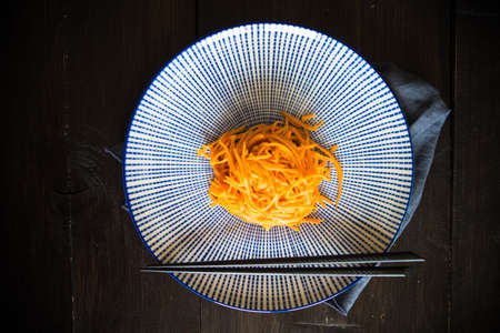 Organic spicy carrot salad on rustic table with copyspace as an organic food conceptの写真素材