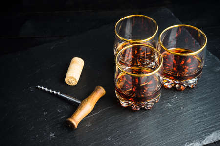 Glacc of cognac with ice on rustic background with copyspaceの写真素材