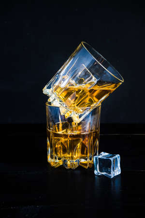 Glacc of cognac with ice on rustic background with copyspaceの写真素材