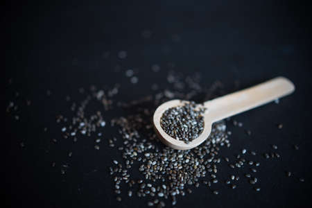 Organic chia seeds on dark wooden table with copyspaceの写真素材