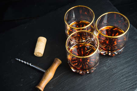 Glacc of cognac with ice on rustic background with copyspaceの写真素材