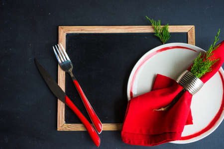 Rustic festive table setting with vintage tableware and Christmas decoration on grey concrete  table with copyspaceの写真素材
