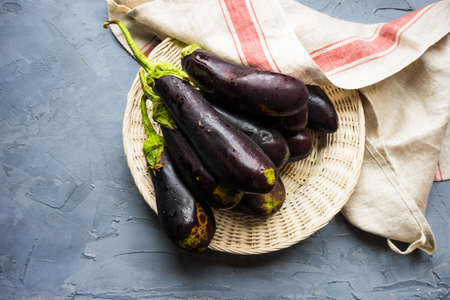 organic food concept with fresh uncooked eggplant on concrete backgoundの写真素材
