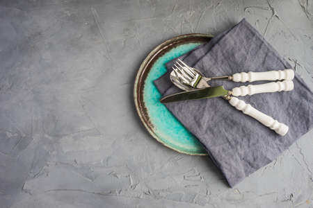 Rustic table setting with vintage tableware  on grey concrete table with copyspaceの写真素材