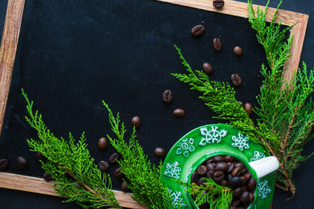 Christmas concet with chalkboard, pine cones  and coffee beans on dark wooden tableの写真素材