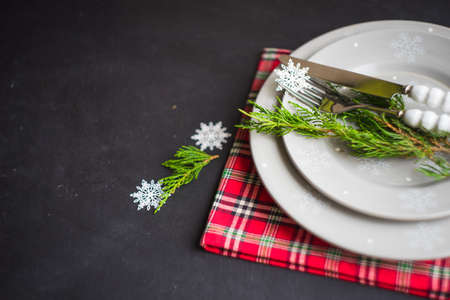 Rustic festive table setting with vintage tableware and Christmas decoration on grey concrete  table with copyspaceの写真素材