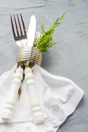 Rustic festive table setting with vintage tableware and Christmas decoration on grey concrete  table with copyspaceの写真素材