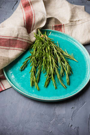 Fresh rosemary spice on dark wooden board with copyspaceの写真素材