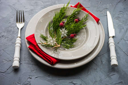 Rustic festive table setting with vintage tableware and Christmas decoration on grey concrete  table with copyspaceの写真素材