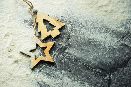 Cooking concept with cookies forms and flour on dark wooden table with copyspaceの写真素材