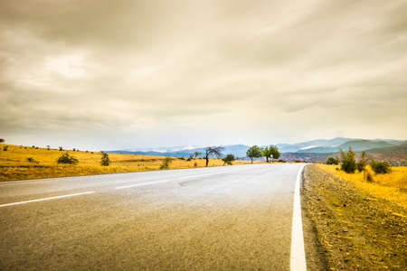 Road in rainy autumnal landscape in Caucasus mountain in Kakheti, wine region of Georgiaの写真素材